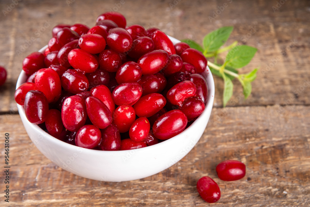 Cornelian cherry, dogwoods edible berry in white bowl Cornelian cherry, dogwoods edible berry in white bowl