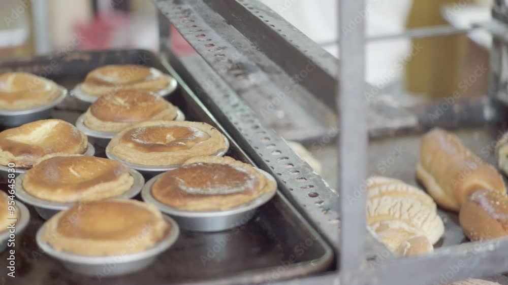 View of fresh pastries on baking sheets in Mexico bakery. Selection of delicious morning treats. Artisanal, handmade baked goods in shop ready for sale. Pan left. View of fresh pastries on baking sheets in Mexico bakery. Selection of delicious morning treats. Artisanal, handmade baked goods in shop ready for sale. Pan left.