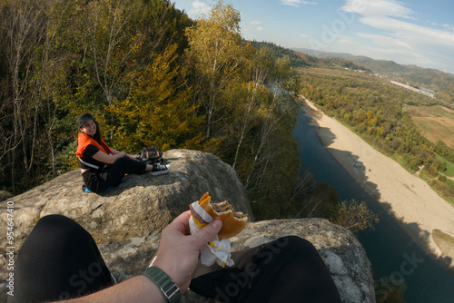 pov Eating Burger at Cliff with Mountain River View