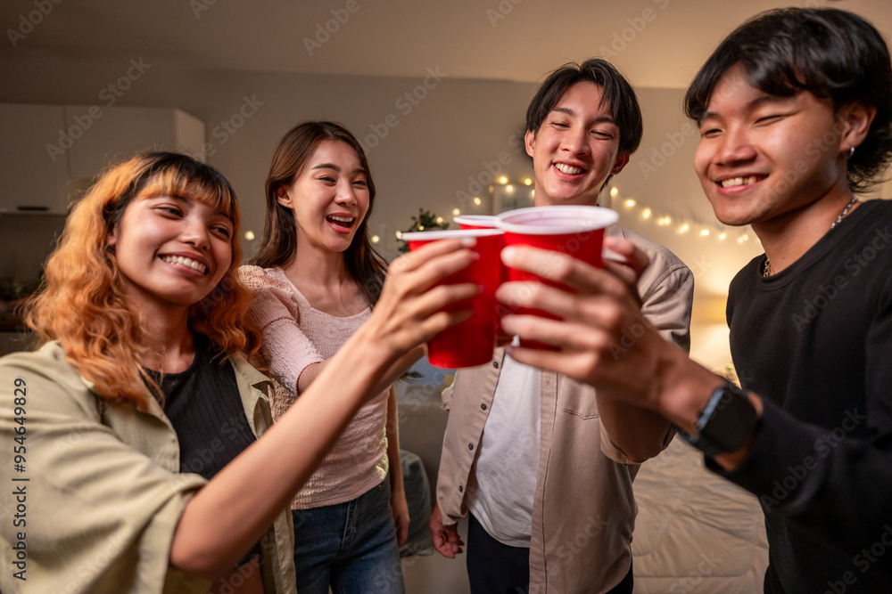 Group of Asian friends having evening party in living room at home. Group of Asian friends having evening party in living room at home.