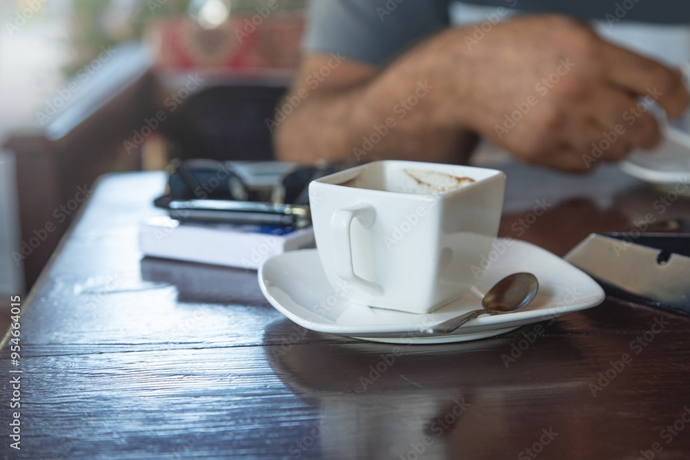 Caucasian man drinking coffee in the outdoor cafe. Caucasian man drinking coffee in the outdoor cafe.