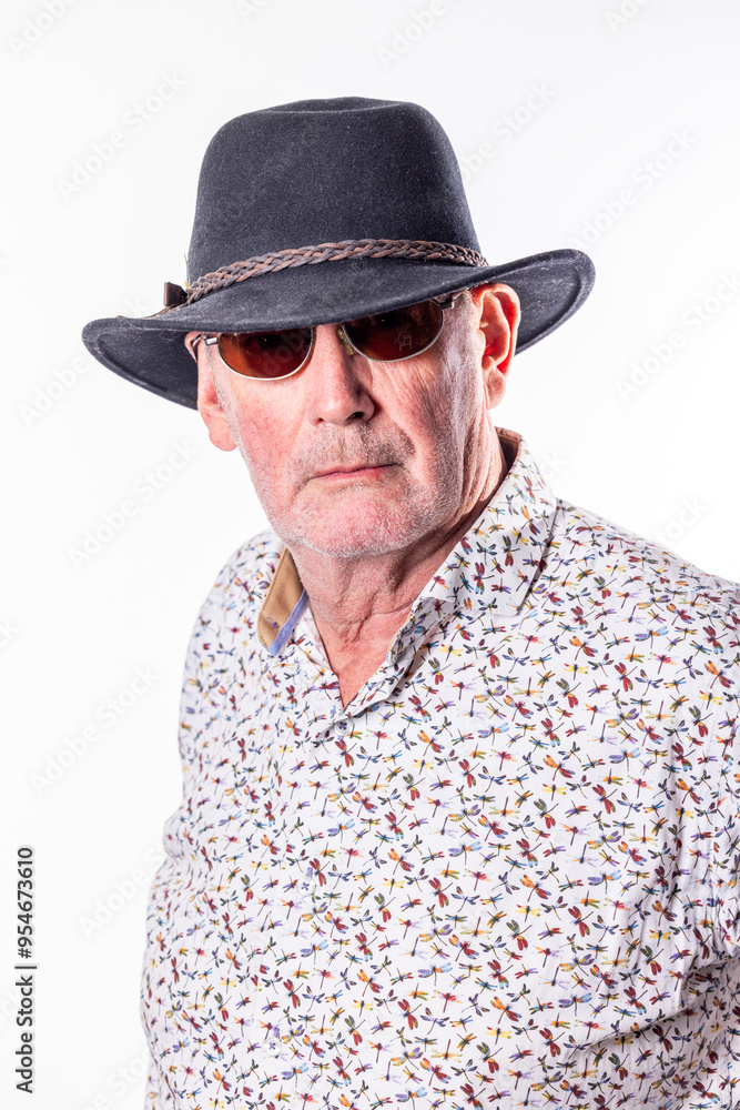 A selfassured older gentleman donning a stylish patterned shirt, fashionable sunglasses, and a comfortable hat A selfassured older gentleman donning a stylish patterned shirt, fashionable sunglasses, and a comfortable hat