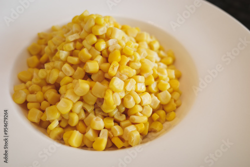 Boiled sweet corn kernels on white dish  photo