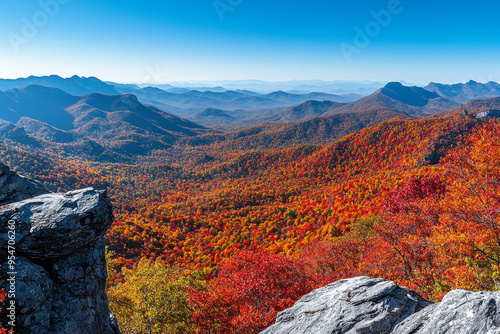 A vibrant autumn landscape showcasing colorful foliage across rolling mountains under a clear blue sky.