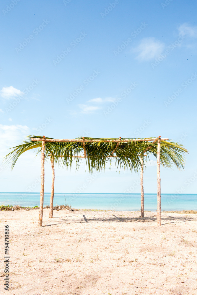 Beach shed with a thatched palm leaf as a roof. Beach shed with a thatched palm leaf as a roof.