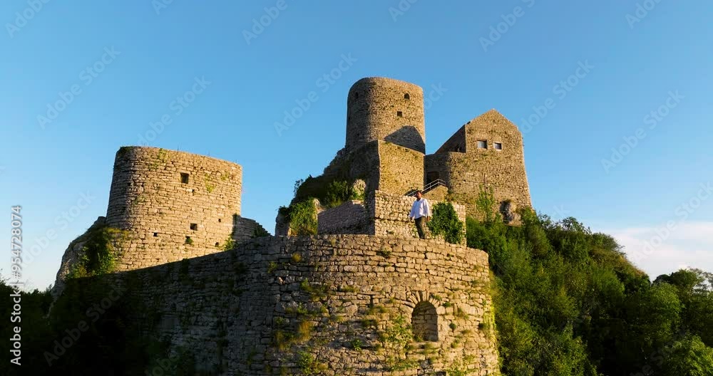 Male Tourist Appreciating Scenic Views At Medieval Castle In Srebrenik, Bosnia And Herzegovina - Aerial Drone Shot Male Tourist Appreciating Scenic Views At Medieval Castle In Srebrenik, Bosnia And Herzegovina - Aerial Drone Shot