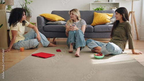 Flatmate girl friends having fun talking, laughing and enjoying breakfast together at home  photo