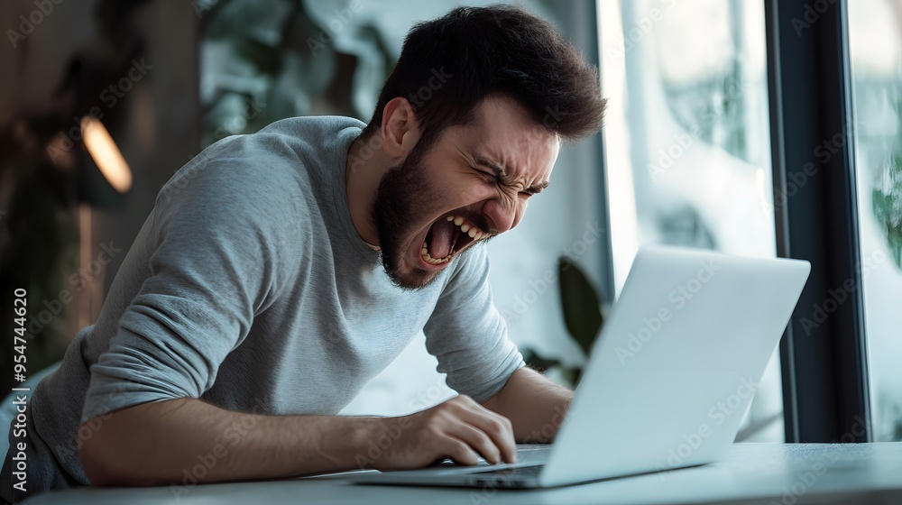 Frustrated man yells at his computer. Frustrated man yells at his computer.