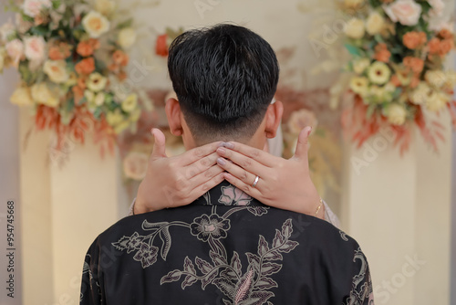 Engagement ring pinning. Showing of the engagement ring. Holding hands. Concept of engagement photo. Indonesian couple