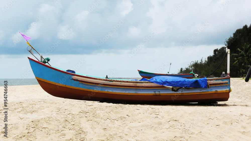 Naklejka premium A fishing boat moored at Marari beach, Alappuzha, Kerala, India