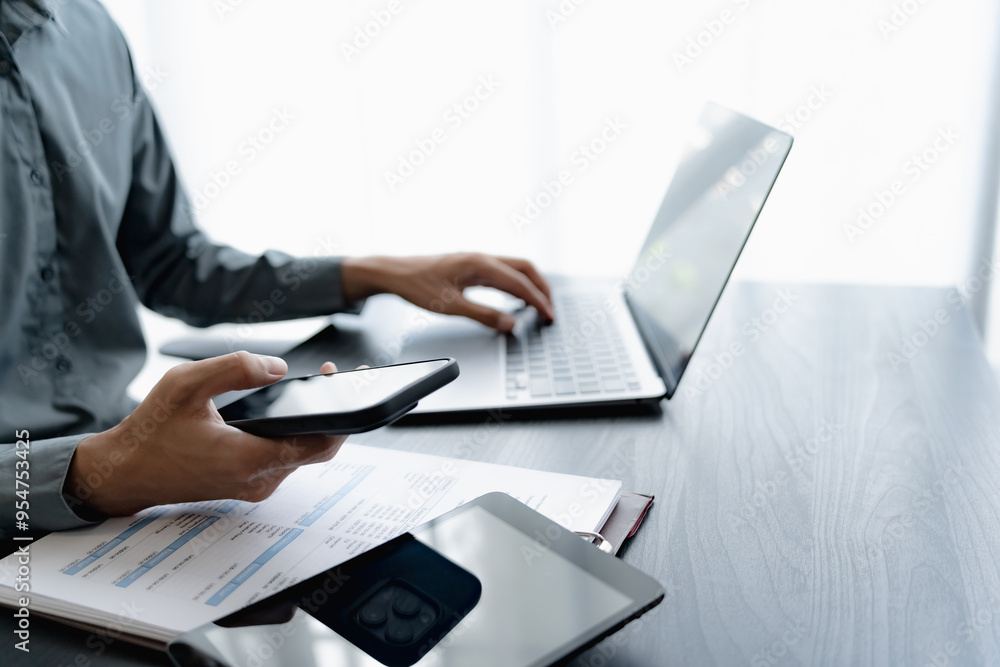 Businessman using mobile phone while working by connecting technology and synchronizing between devices. Businessman using mobile phone while working by connecting technology and synchronizing between devices.
