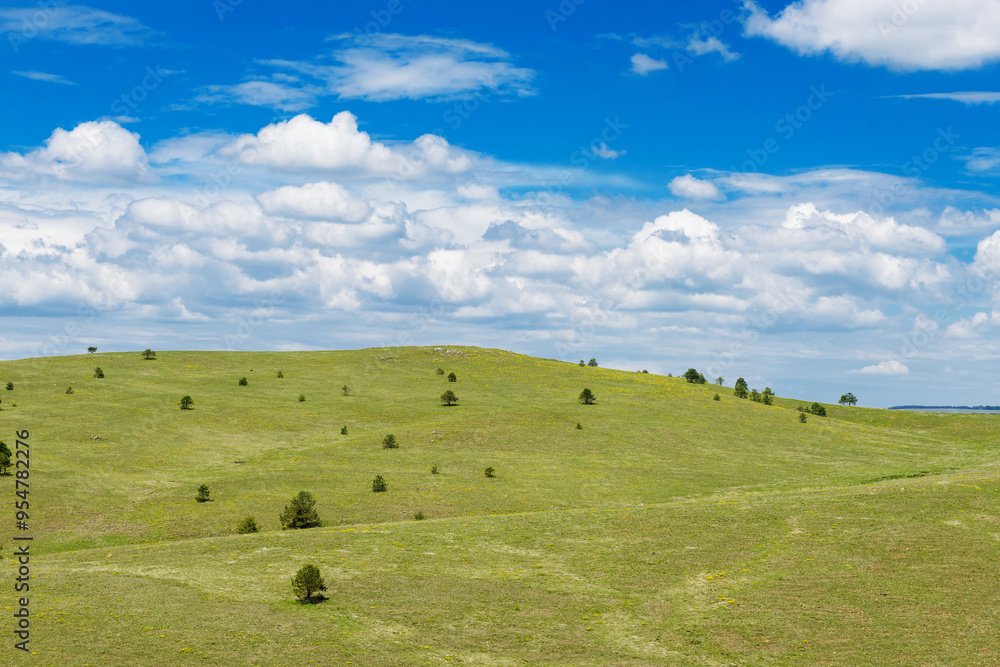 green hills against blue sky with white clouds in summer on a sunny day green hills against blue sky with white clouds in summer on a sunny day
