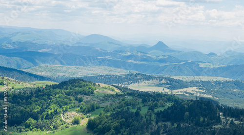 Picturesque mountains near the town of Zlatibor. View of the forest in the mountainous area in summer with blue sky with clouds