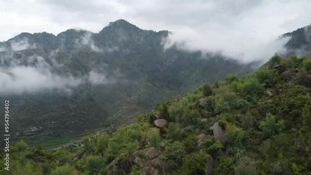 Drone beautiful view of mountains covered by clouds and greenery and valley Drone beautiful view of mountains covered by clouds and greenery and valley