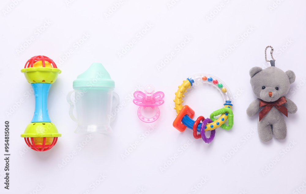 Toys for newborns, feeding accessories on a white background. Flat lay Toys for newborns, feeding accessories on a white background. Flat lay