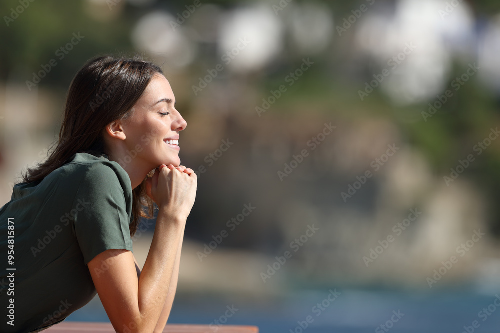 Woman relaxing with closed eyes in a terrace on the beach Woman relaxing with closed eyes in a terrace on the beach