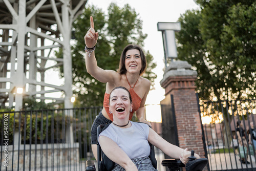 Joyful moments with friends, one using a wheelchair photo