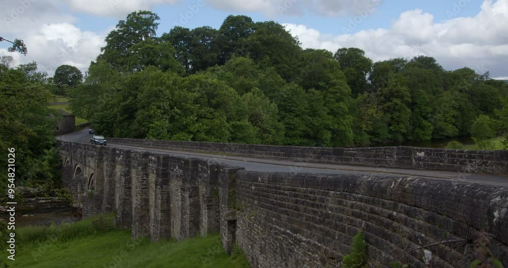 side on shot of grassington bridge showing the road with cars going left to right in the Yorkshire Dales side on shot of grassington bridge showing the road with cars going left to right in the Yorkshire Dales