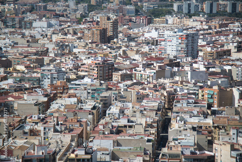  A full-frame capture of Alicante, a large city in Spain, showcasing its mix of whitewashed walls, and both high and low-rise buildings in the urban landscape.