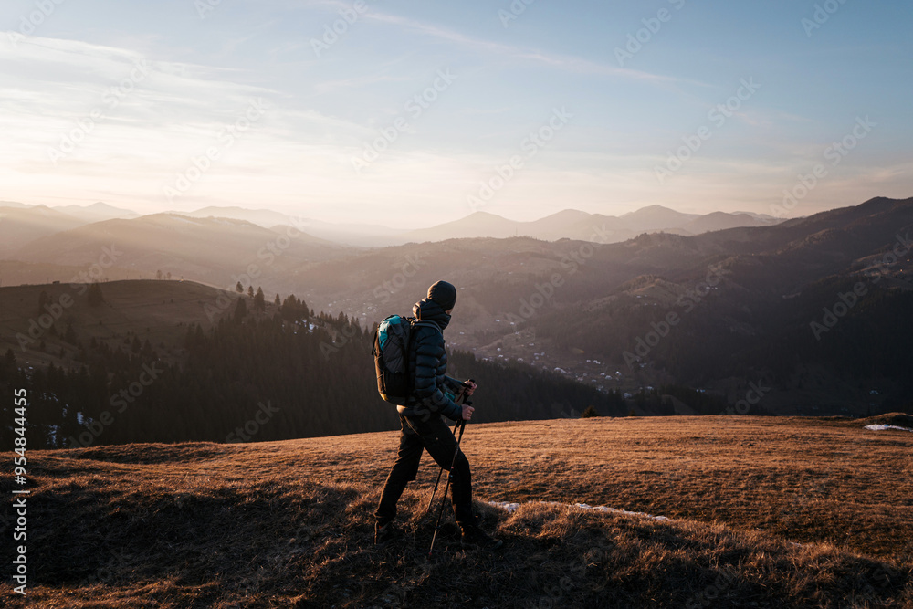 Fototapeta premium Solo Hiker Walking at Sunset on Mountain Ridge