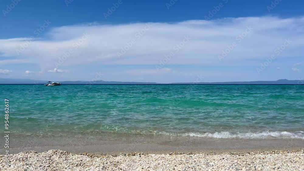 Amazing pebble beach with small waves on summer day Amazing pebble beach with small waves on summer day