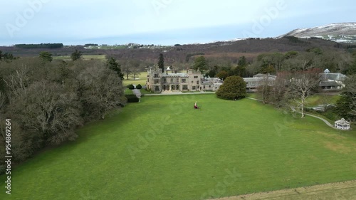 Luxury Property Estate Manor Countryhouse Mansion uk england panning right to left drone aerial helicopter parked front photo