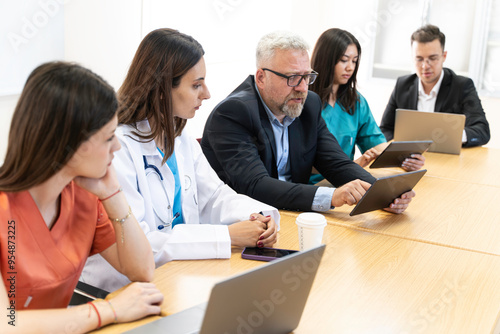 Group of Medical Team and Business People Meeting in Hospital and Office Conference Room