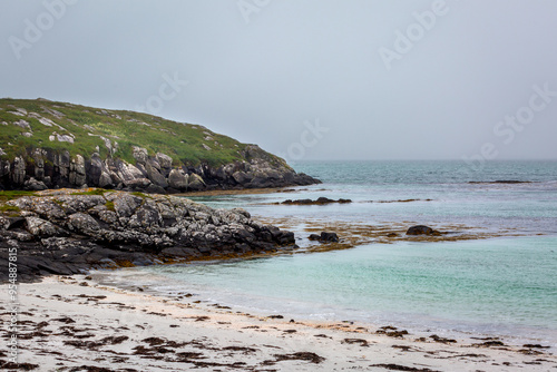 View of the Eriskay coastline, Image shows the remote Scottish islands coastline and the Atlantic ocean on a cloudy summers day  photo