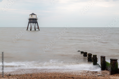 Lighthouse in the sea long exposure, Dovercourt lighthouse at high tide built in 1863 and discontinued in 1917 and restored in 1980 the lighthouse is still a iconic sight on a cloudy evening  photo