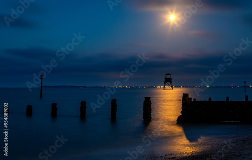 Dovercourt lighthouse at night, Image shows the historic lighthouse along Dovercourt beach illuminated by the moon on a late evening with long exposure photo