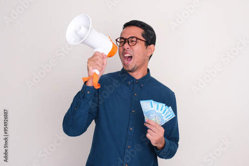 A man give announcement using megaphone while holding money photo