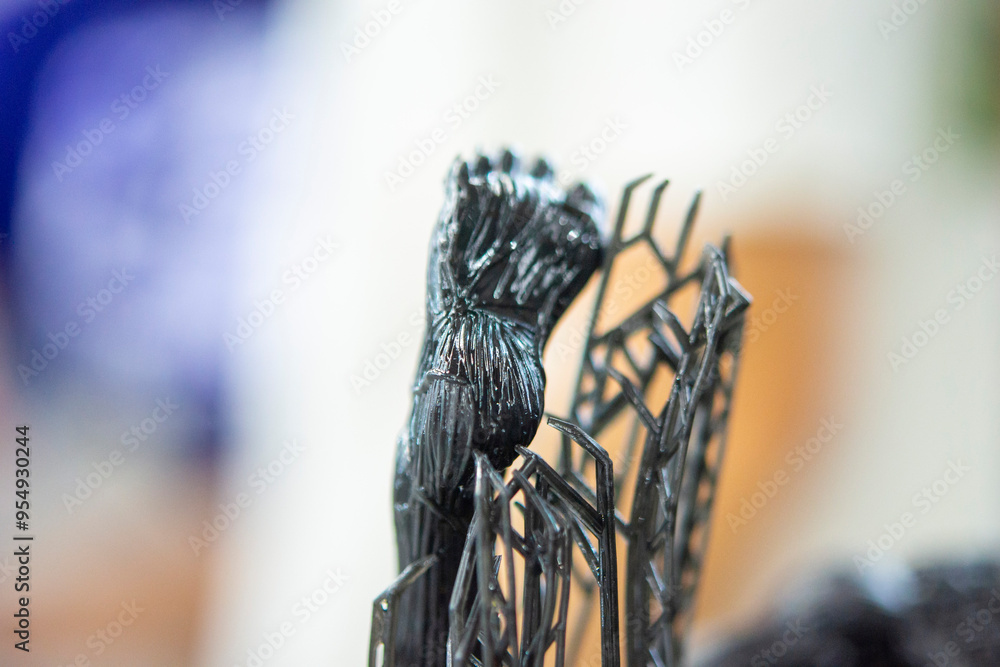 Model of leg printed on a 3D printer from black rubber, close-up. Part of an object created on a 3D printer from hardened rubber under the influence of ultraviolet light. SLA 3D printing technology. Model of leg printed on a 3D printer from black rubber, close-up. Part of an object created on a 3D printer from hardened rubber under the influence of ultraviolet light. SLA 3D printing technology.