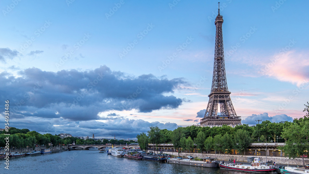 Fototapeta premium The Eiffel Tower day to night Timelapse with boat station. Paris, France