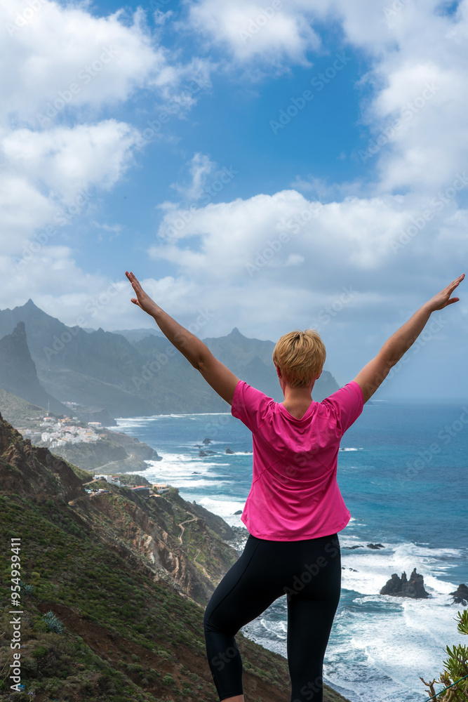Woman hiker watching beautiful costal scenery. - Tenerife, Canary Islands, Spain. coast view, Woman hiker watching beautiful costal scenery. - Tenerife, Canary Islands, Spain. coast view,
