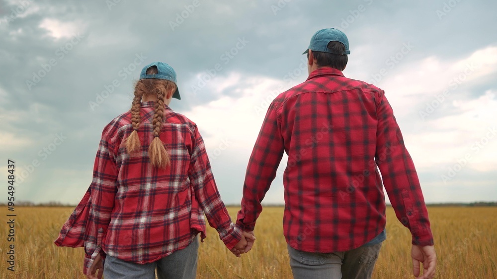 Family of farmers gathered to haest wheat. Field farmer farm concept. A couple of people walking through the wheat. A couple of farmers walking together lifestyle in a field of wheat. Family of farmers gathered to haest wheat. Field farmer farm concept. A couple of people walking through the wheat. A couple of farmers walking together lifestyle in a field of wheat.