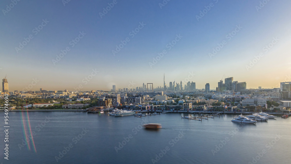 Dubai creek landscape timelapse with boats and ship and modern buildings in the background during sunset Dubai creek landscape timelapse with boats and ship and modern buildings in the background during sunset