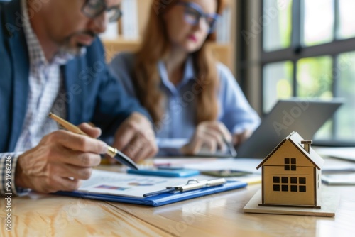 An agent is discussing mortgage options with clients in a cozy office photo