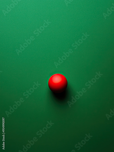 A vibrant red ball resting on a smooth green surface, creating a striking visual contrast. Ideal for minimalist design themes.