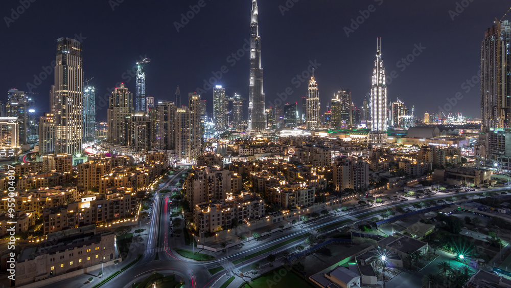 Fototapeta premium Dubai Downtown skyline night timelapse with Burj Khalifa and other towers panoramic view from the top in Dubai