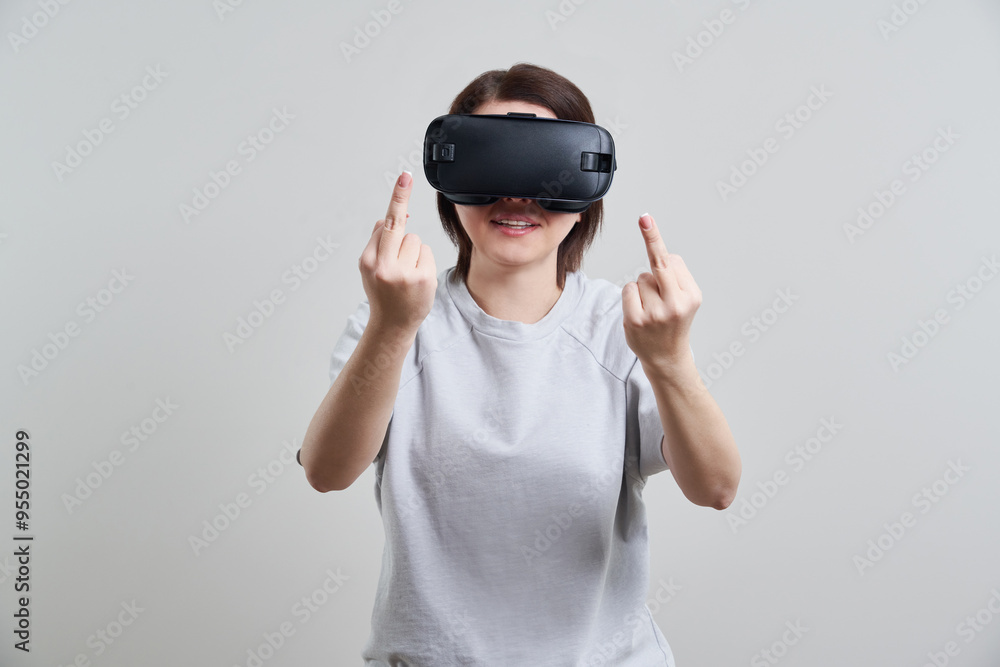 Happy young woman playing on VR glasses indoor, Virtual reality concept with young girl having fun with headset goggles, with copy space Happy young woman playing on VR glasses indoor, Virtual reality concept with young girl having fun with headset goggles, with copy space