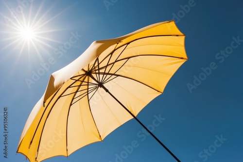 Orange beach umbrella, clear sunny day with a blue sky in the background, summer and vacation concept. photo