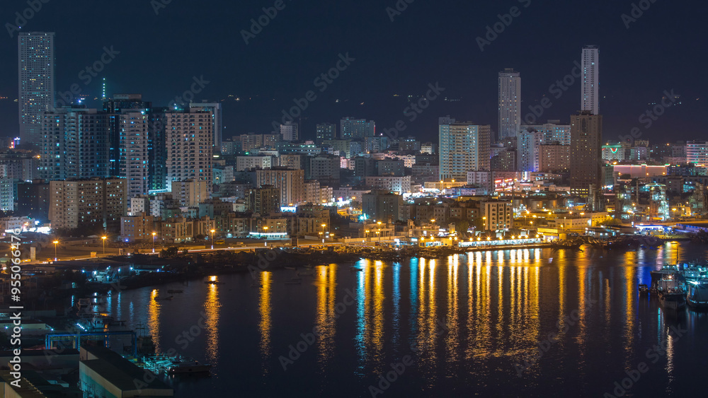 Cityscape of Ajman aerial view from rooftop at night timelapse. United Arab Emirates. Cityscape of Ajman aerial view from rooftop at night timelapse. United Arab Emirates.