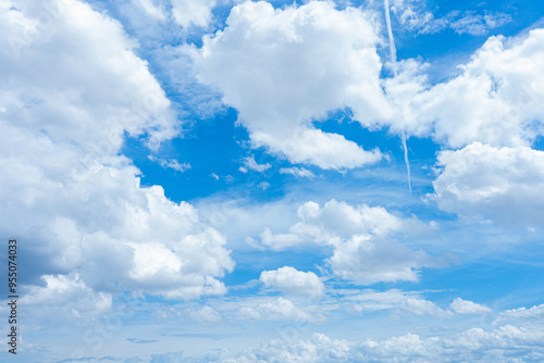 Bright blue sky with fluffy white clouds on a sunny day photo