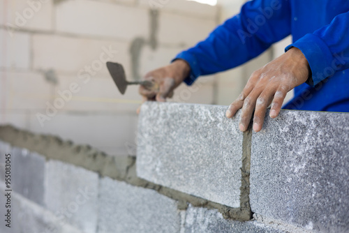 Close up hand construction mason worker bricklayer Engineering people, man construction worker and architecture bricklayers working in work at house construction site. Caucasian men