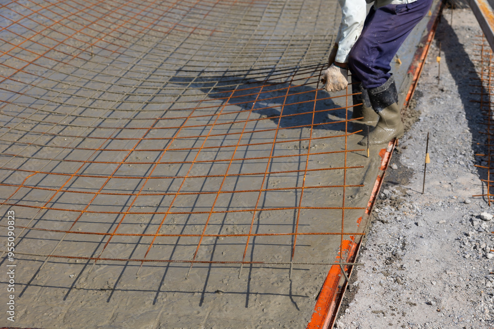 steel rebar framework cement. Engineering people, construction site. construction worker and architecture pouring wet concret in road construction site. Caucasian men steel rebar framework cement. Engineering people, construction site. construction worker and architecture pouring wet concret in road construction site. Caucasian men