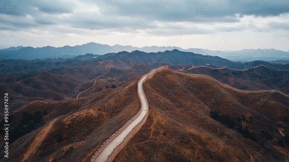 Aerial view of an empty Great Wall of China, stretching across the landscape with no people in sight, under a cloudy sky Aerial view of an empty Great Wall of China, stretching across the landscape with no people in sight, under a cloudy sky