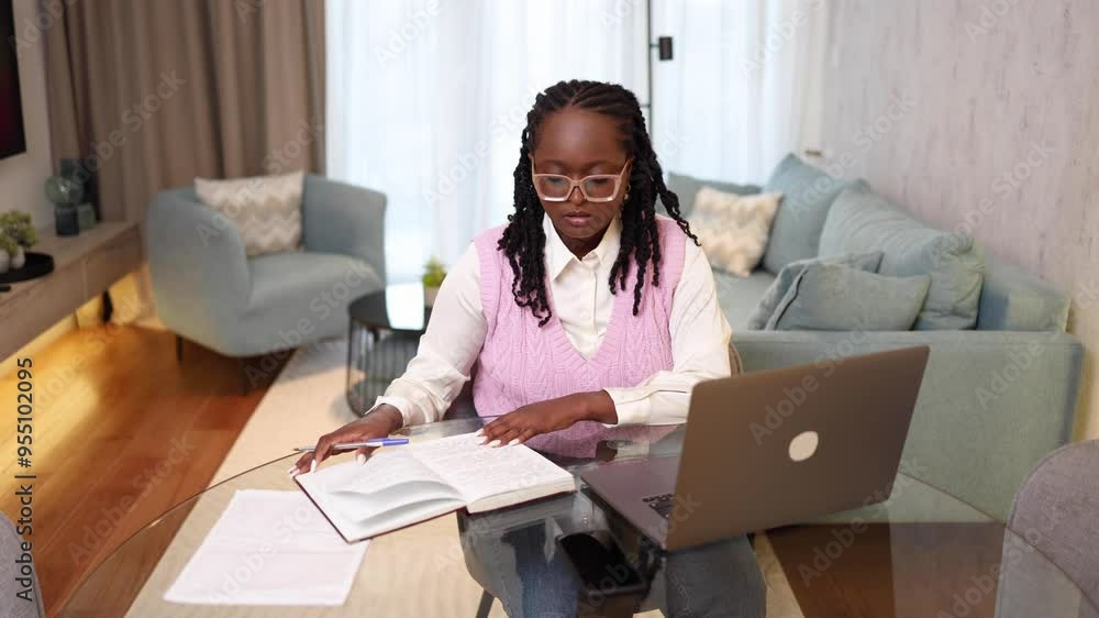 African American woman working on a laptop at her home office and feeling tired from working hard African American woman working on a laptop at her home office and feeling tired from working hard