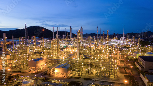 Oil Refinery plant at sunset. Gas Chemical Equipment Prodiction import export Concept, Crude Oil Refinery Plant Steel Pump Pipe line and Chimney and Cooling tower, Chemical Petrochemical photo