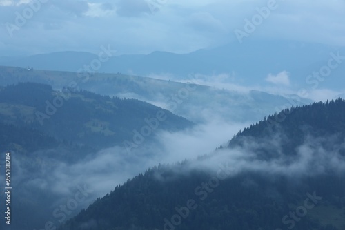 Picturesque view of beautiful mountains covered with fog