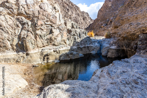 Wadi Shawka pools mountain trail in Hajar Mountains, United Arab Emirates, stony, almost dry riverbed in rocky valley.